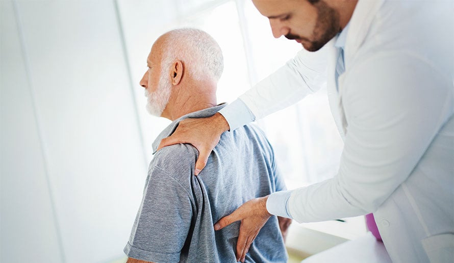 Man with back pain visiting doctor's office