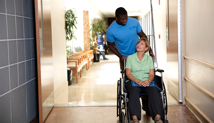 volunteer helping patient in wheelchair