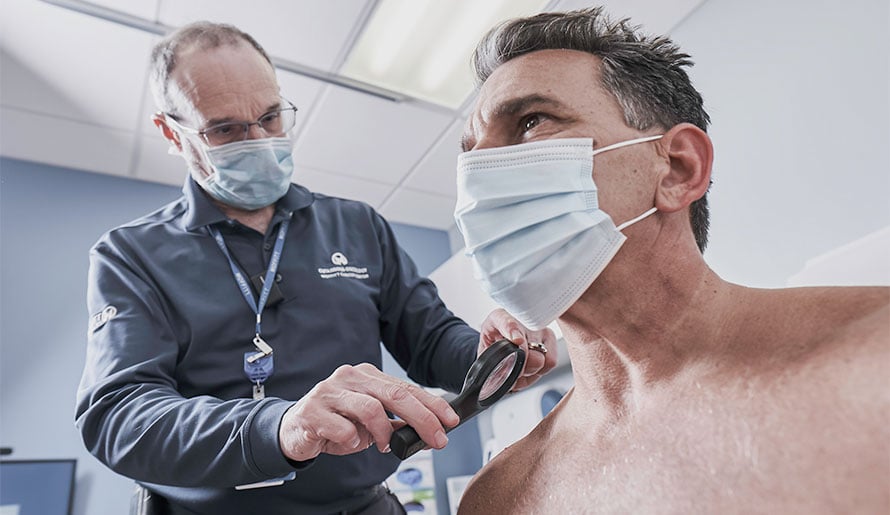 Dr. Vernon Sondak checking skin for melanoma