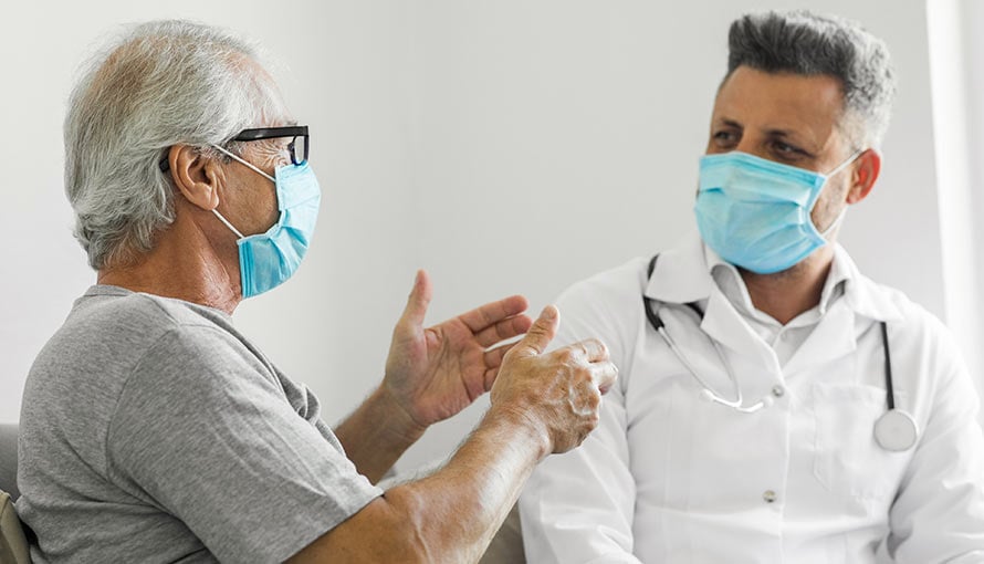 A doctor listening to a patient