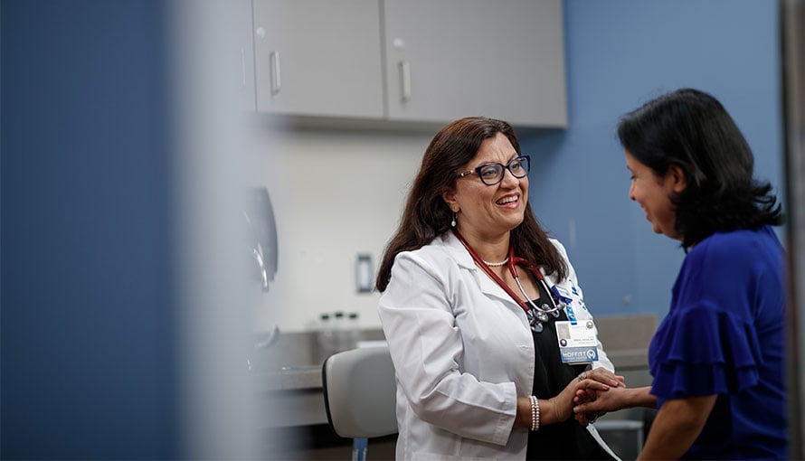 Hispanic doctor speaking with patient at Moffitt
