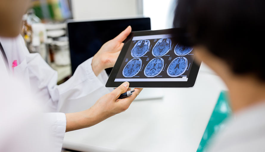 Doctors look at x-rays of a patient's skull