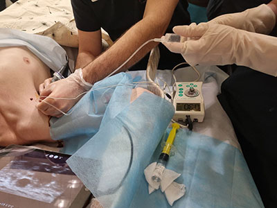 A soldier in a Zaporizhzhia hospital who was wounded by a firearm receives an ultrasound-guided cervical plexus block.