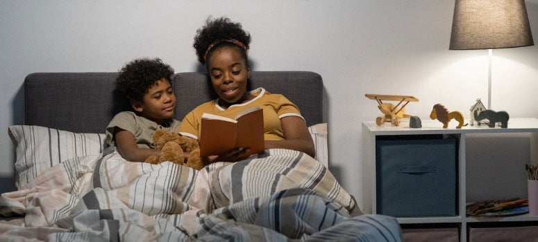 Mom reads a bedtime story to her daughter.