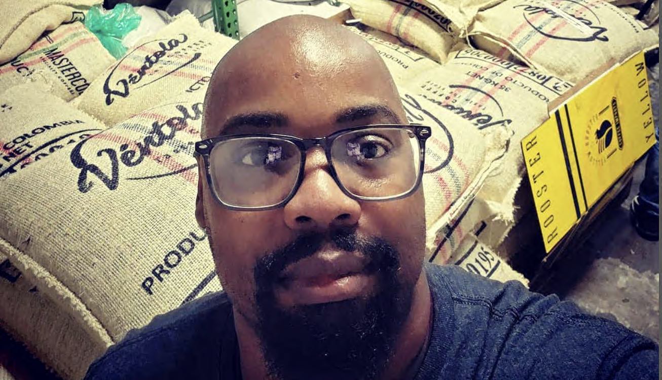 Gary with sacks of coffee beans for his own company, Bright Land Coffee 