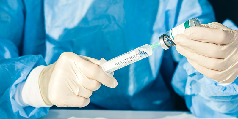 medical professional with vaccine syringe