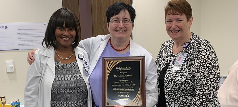 McDaniel and Extermann accept the PFAC Award of Excellence from PFAC Co-Chair Shani Parkin