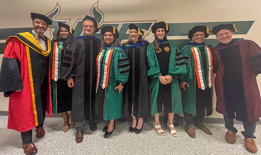 USF graduates with Moffitt faculty
