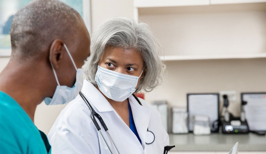 Male with kidney cancer talking to nurse