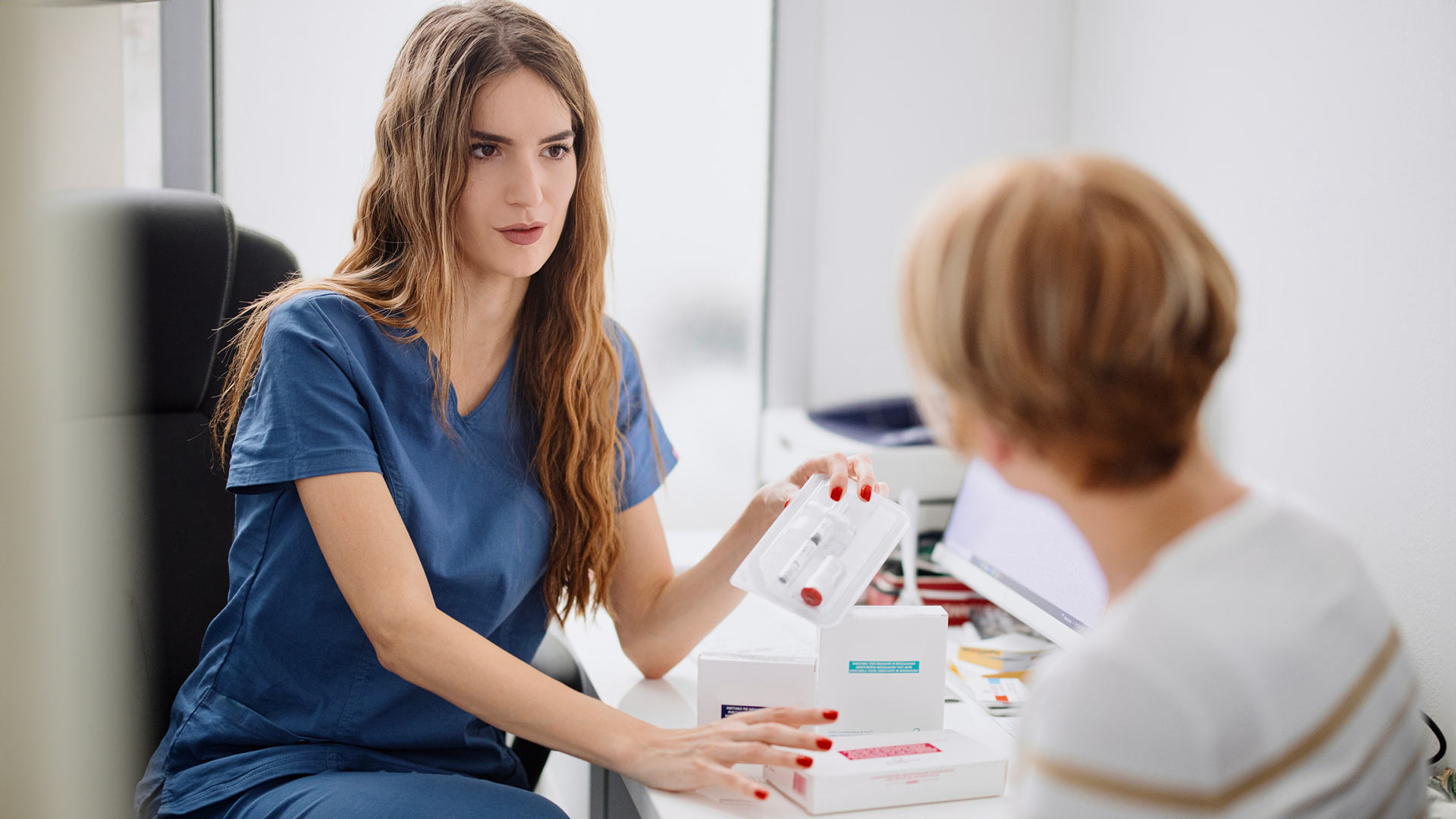 A Medical Assistant talks to a patient