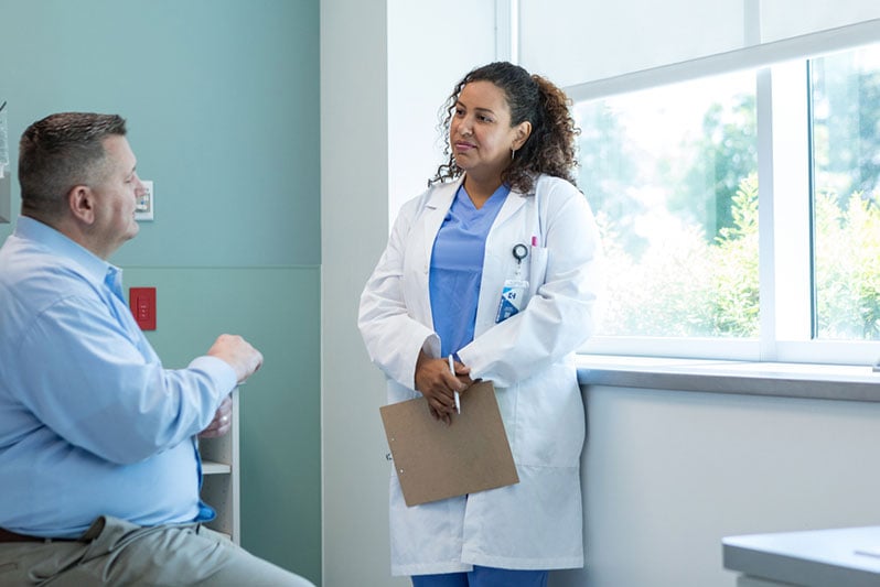 Doctor discussing warning signs on hemorrhoids