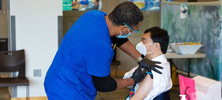 Dr. Patrick Hwu receives the COVID-19 vaccine.