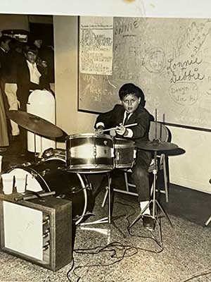 When he first started playing at age 5, Zalva fell in love with the drums and has been hooked ever since. By age 12, he already had his own band, The Shantelles. That’s him gigging out at the Palma Ceia Country Club in the photo. 