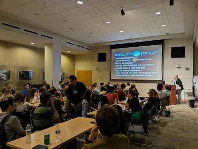 image of workshop participants sitting at tables talking to one another