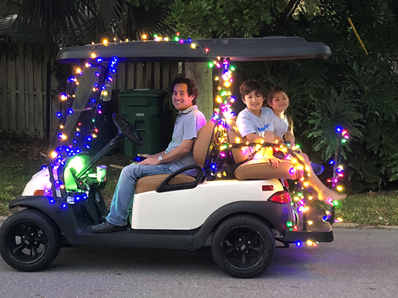 Dr. Catherine Lee's husband and two children enjoy a festive golf cart ride.