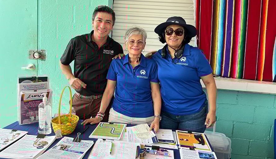 COE members at table with cancer prevention flyers
