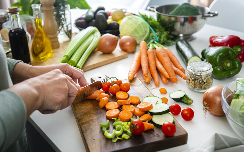 a person cropping vegetables