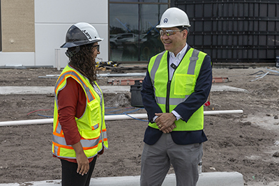 Moffitt CEO Patrick Hwu, MD, speaks with Jazmin Calzada, director of Nursing and Ambulatory Clinic Operations outside the Moffitt at Southshore main entrance.