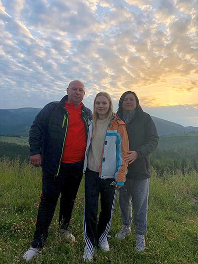 Anna Iermolaieva posing in a photo with her parents in the Ukraine.