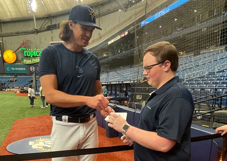Tampa Bay Rays pitcher Tyler Glasnow shares his autograph with Ausley during Moffitt Night at Tropicana Field.
