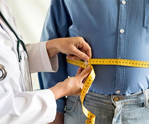 Man getting waist measured