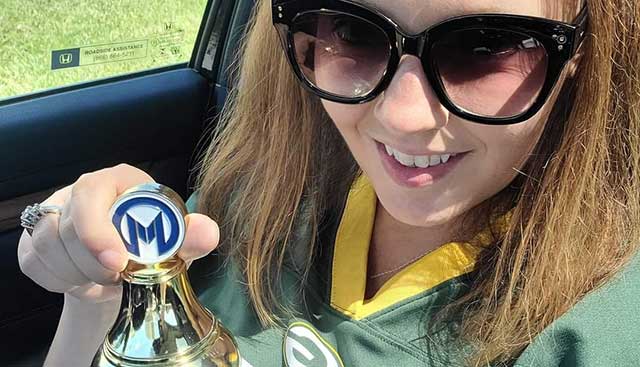 Colorectal cancer patient displaying her Moffitt trophy 