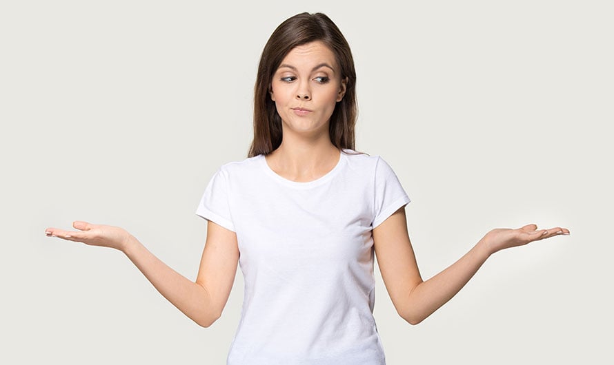 woman with arms raised in question
