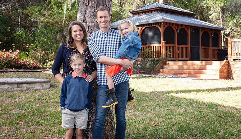 The Morris family poses outside their home.