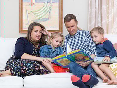 Caleb reads to his two children, Summer Jo and Rowdy.