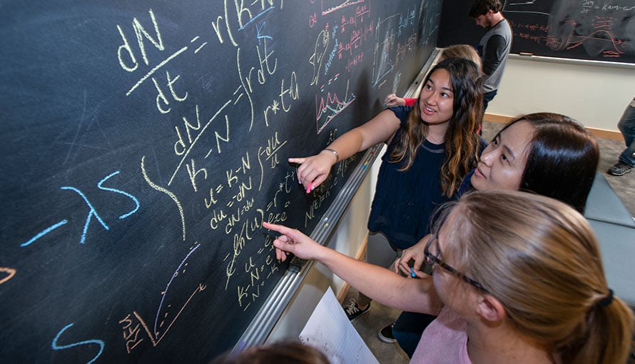researcher work at chalkboard