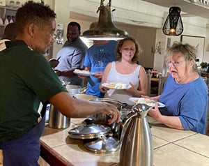 Marilyn Masick tries nshima, a popular porridge dish in Zambia.