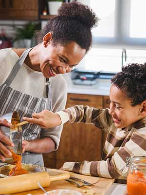 Son helps mother with baking
