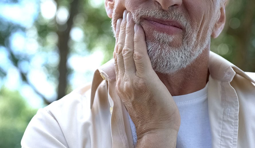 Man feeling pain in his jaw