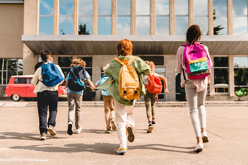 Middle school kids walking toward a school