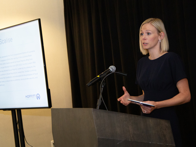 photo of Alyene Mlinar speaking at a podium