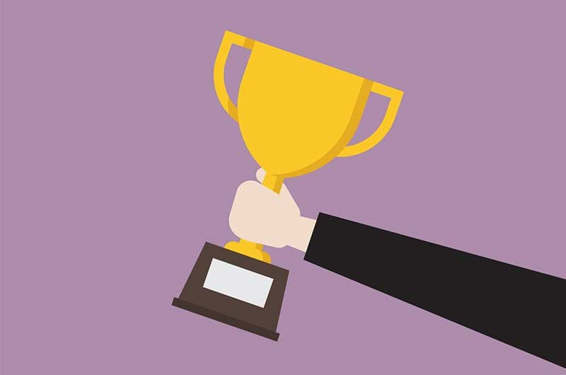 hand passing winning trophy