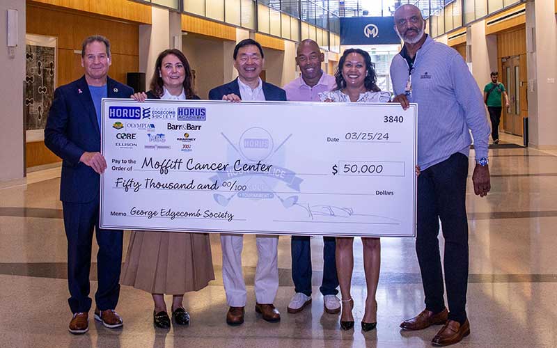 The George Edgecomb Society presents a large check