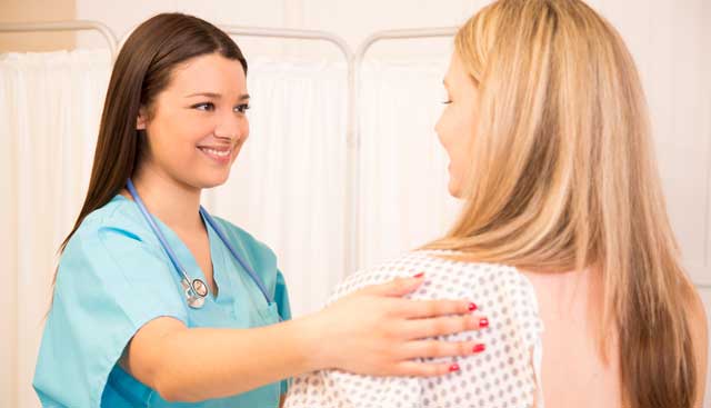 A woman getting a breast exam