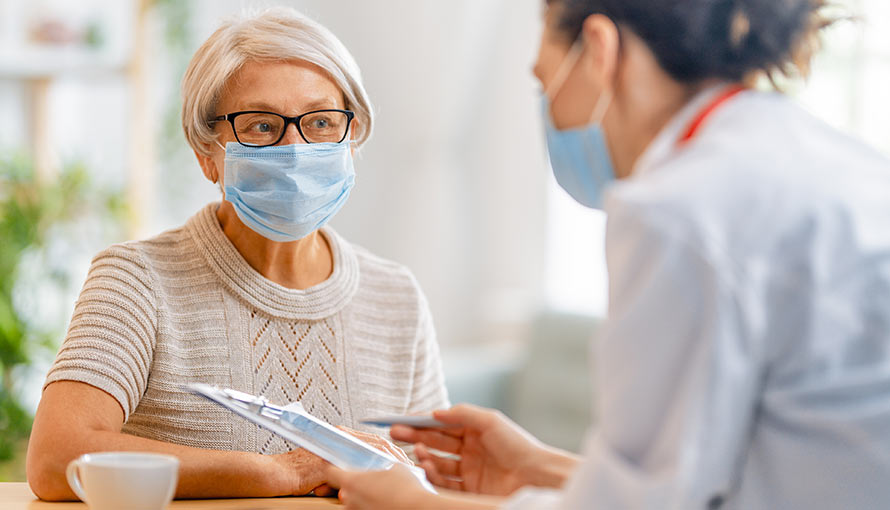 A doctor helping a patient with paperwork
