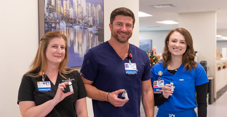 With the help of Pharmacy’s Erika Richter, left, and Shawn Huss, Mankewich was able to collect bottles for the project.