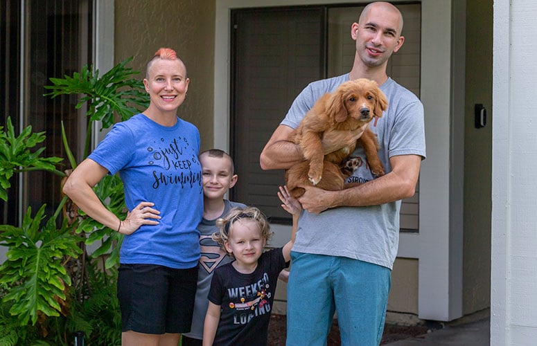 Amy, Landen, Corben and Callen pose with their new dog, River.