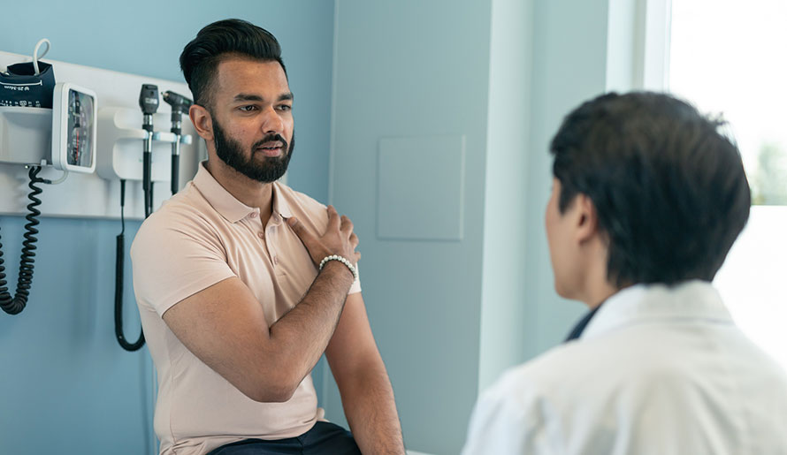Doctor describing osteosarcoma causes to patient