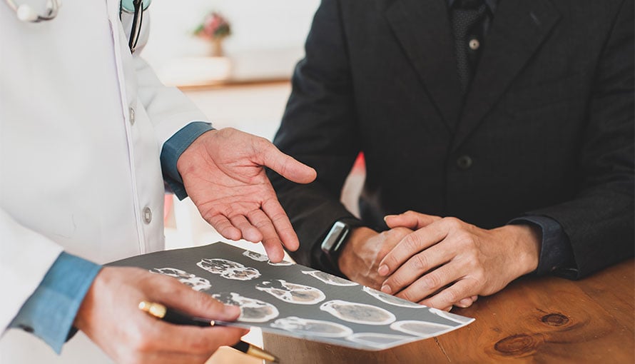 Skull base tumor patient looking at MRI scan