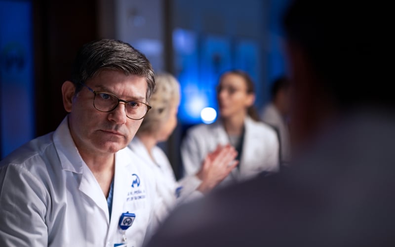 Luis Pena, MD, talking with colleague