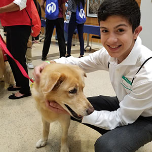 Volunteen Andrew meets pet therapy dog