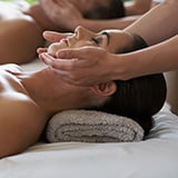 A woman receives a soothing massage in a tranquil spa setting, enhancing her relaxation and well-being.