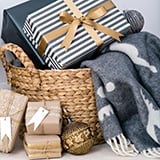 A decorative basket overflowing with wrapped presents, each featuring a colorful bow.