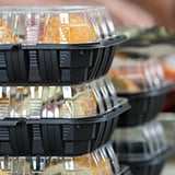 A neatly arranged stack of transparent plastic food containers, each filled with different meals for convenient storage.
