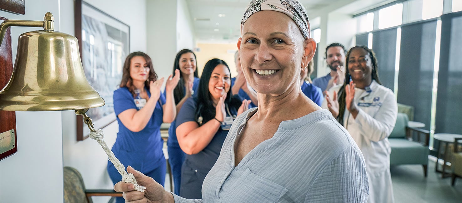 A patient rings a bell to celebrate the end of cancer treatments