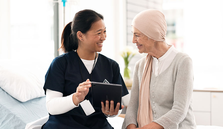 Nurse talks to patient about pancreatic cancer causes
